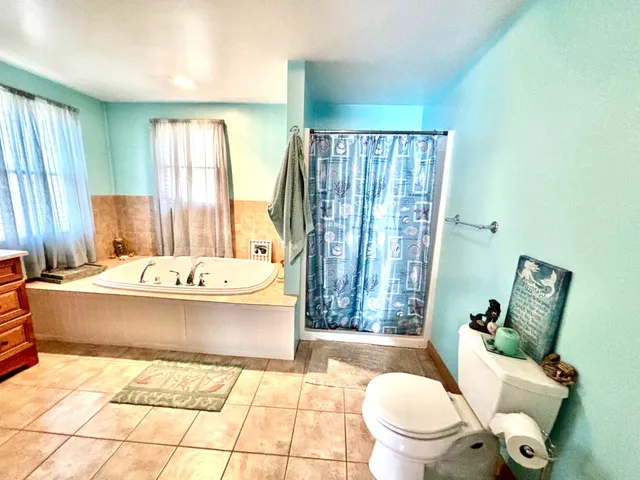 a spacious bathroom with a bathtub and sink