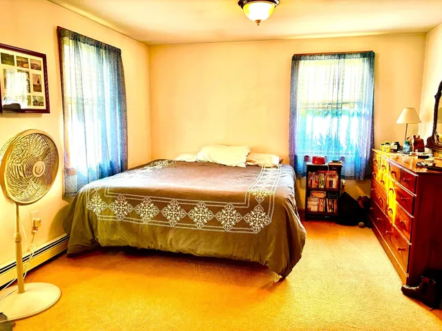 a bed sitting in a bedroom next to a window