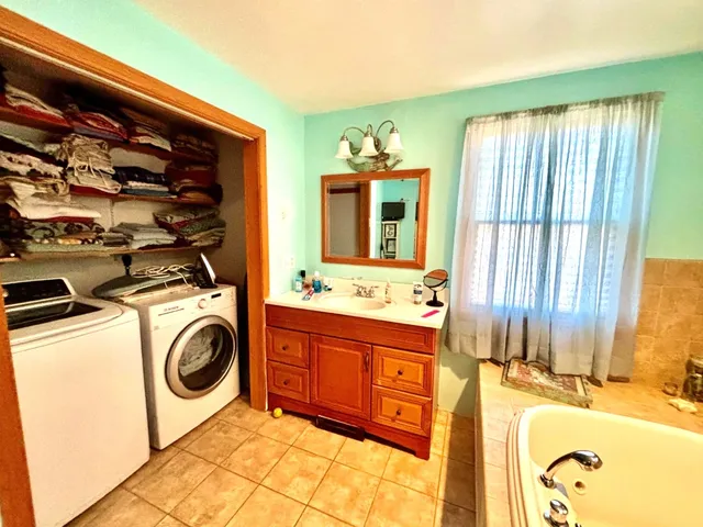 a bathroom with a sink mirror and a bathtub