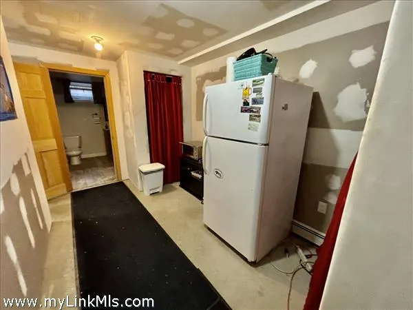 a view of a kitchen with refrigerator and a dishwasher