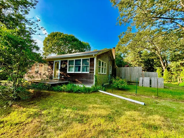 a view of an house with backyard space and garden