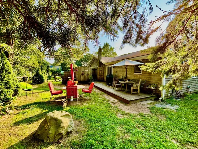 a view of a swimming pool with a bench and trees