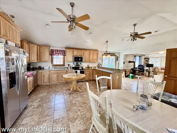 a living room with stainless steel appliances kitchen island granite countertop furniture and a kitchen view