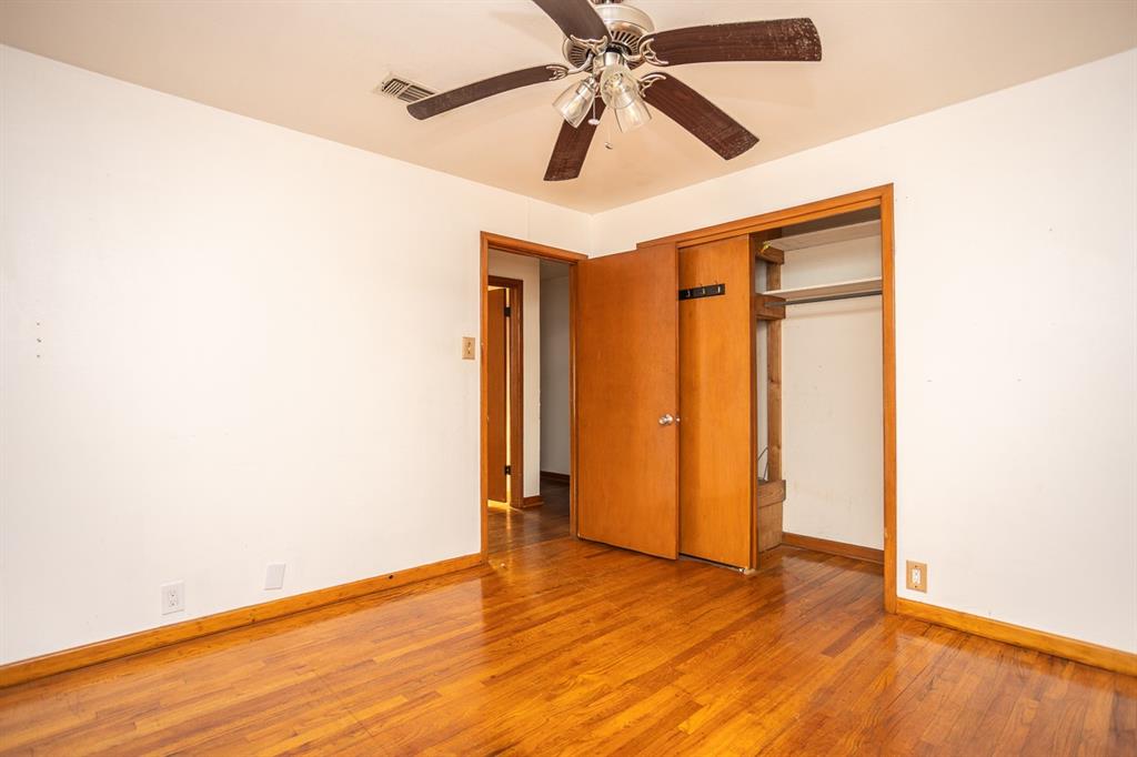 1414 Rice Avenue Gainesville, TX 76240 - Photo 13 of 21 a view of an empty room with wooden floor
