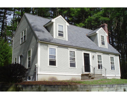 22 Wallace Road Groton, MA 01450 - Photo 1 of 5 a front view of a house with a yard