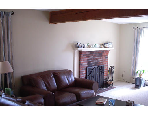 22 Wallace Road Groton, MA 01450 - Photo 3 of 5 a living room with furniture and a fireplace