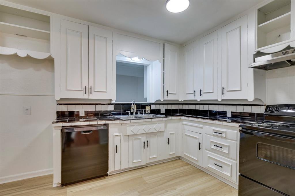 617 Wilson Street Lancaster, TX 75146 - Photo 12 of 30 a kitchen with granite countertop white cabinets and white appliances