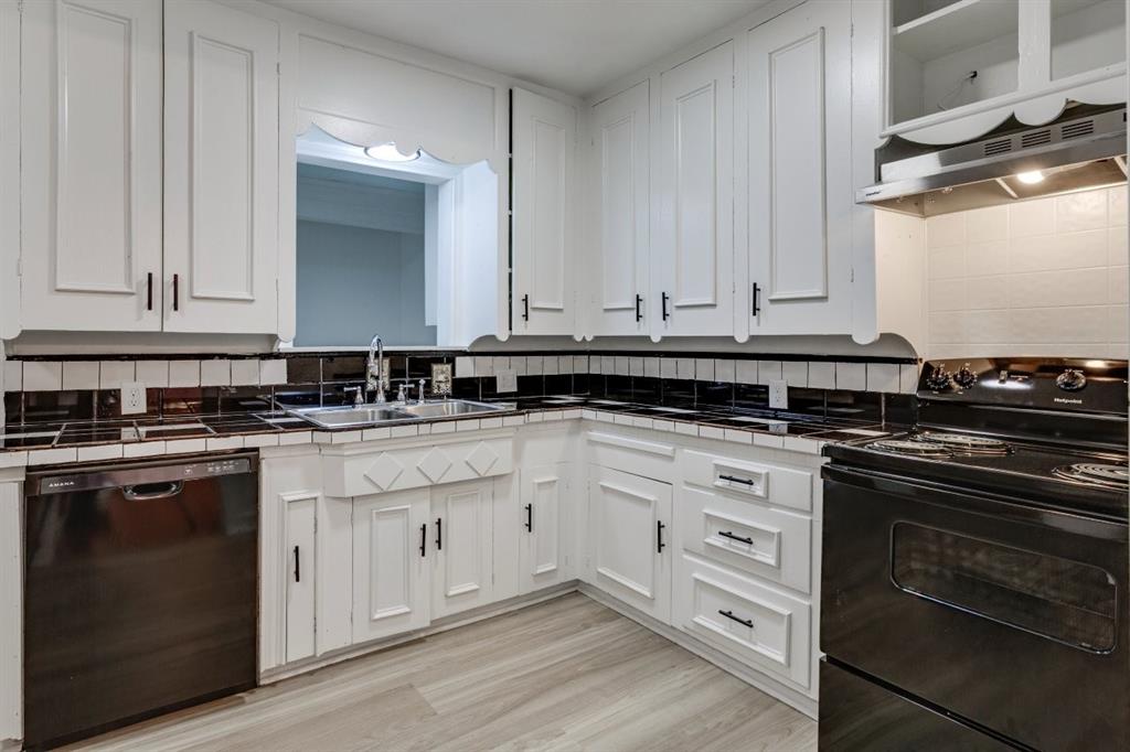 617 Wilson Street Lancaster, TX 75146 - Photo 13 of 30 a white kitchen with granite countertop white cabinets and a stove
