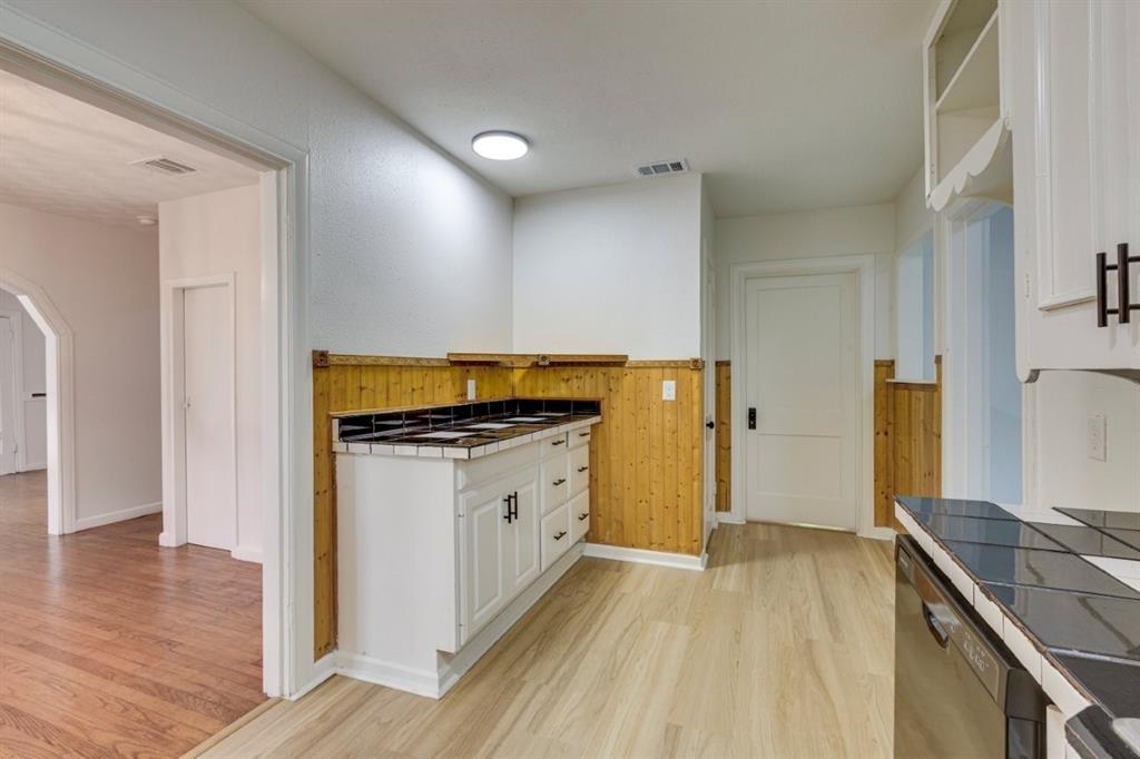 617 Wilson Street Lancaster, TX 75146 - Photo 16 of 30 a kitchen with granite countertop a stove and a refrigerator