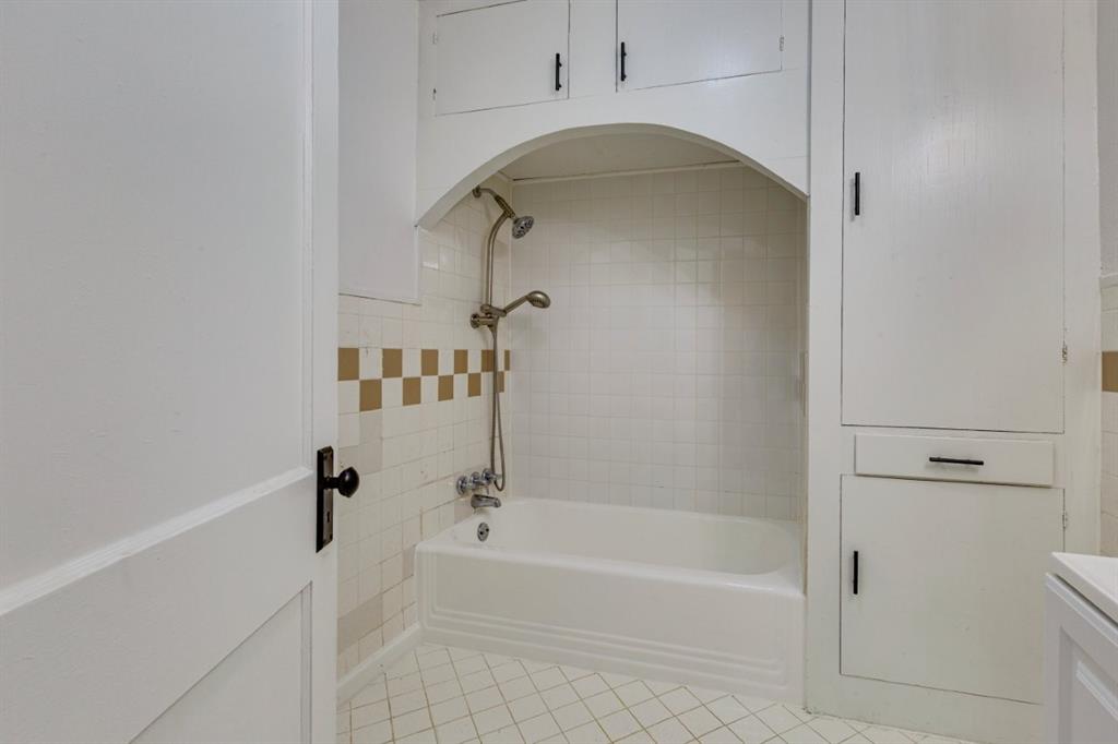 617 Wilson Street Lancaster, TX 75146 - Photo 24 of 30 a bathroom with a bathtub and a shower