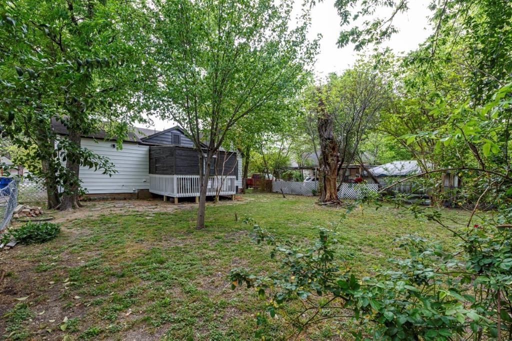 617 Wilson Street Lancaster, TX 75146 - Photo 30 of 30 a small garden covered with tall trees
