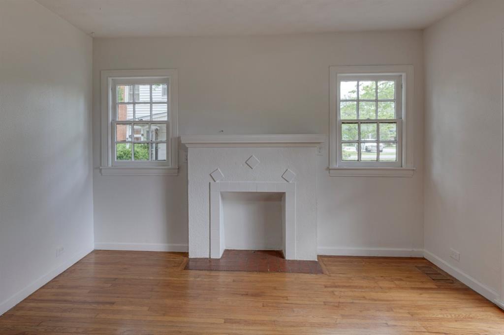 617 Wilson Street Lancaster, TX 75146 - Photo 7 of 30 wooden floor fireplace and windows in an empty room