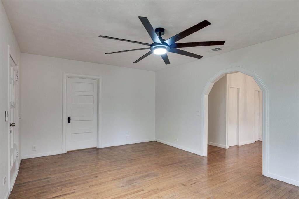 617 Wilson Street Lancaster, TX 75146 - Photo 8 of 30 an empty room with wooden floor closet and fan