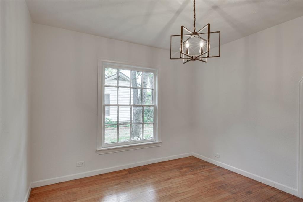 617 Wilson Street Lancaster, TX 75146 - Photo 10 of 30 an empty room with a window and wooden floor