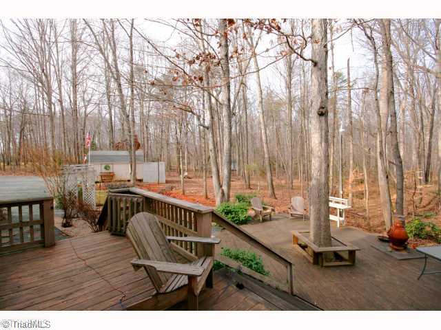 115 Brann Road Browns Summit, NC 27214 - Photo 13 of 16 Patio/Deck. Nice Backyard decking and pleasent wooded lot.