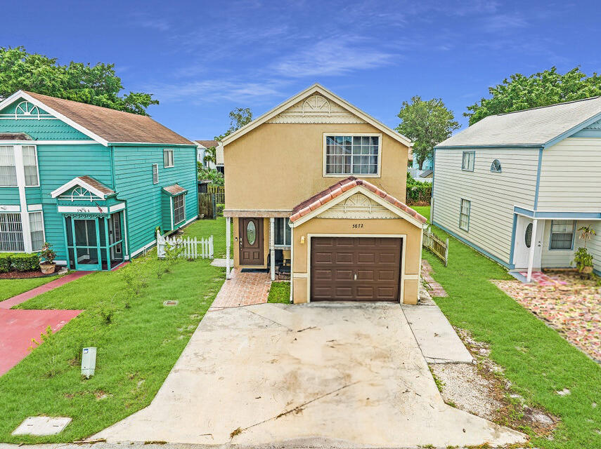 5872 Rambler Rose Way West Palm Beach, FL 33415 - Photo 1 of 30 a front view of a house with a yard