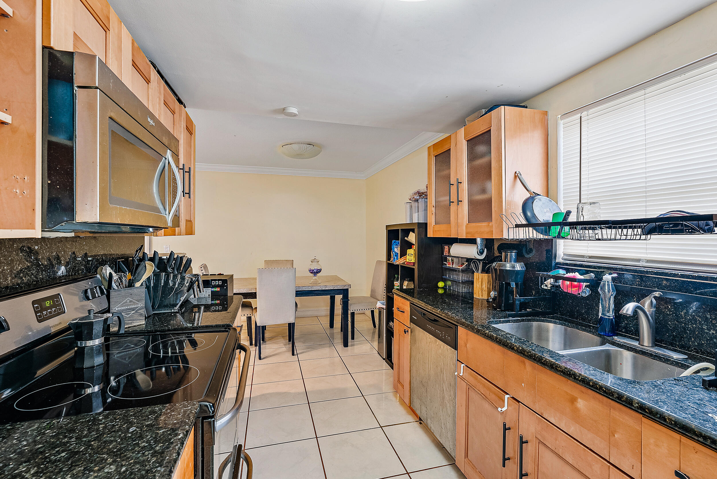 5872 Rambler Rose Way West Palm Beach, FL 33415 - Photo 11 of 30 a kitchen with a sink and a stove top oven