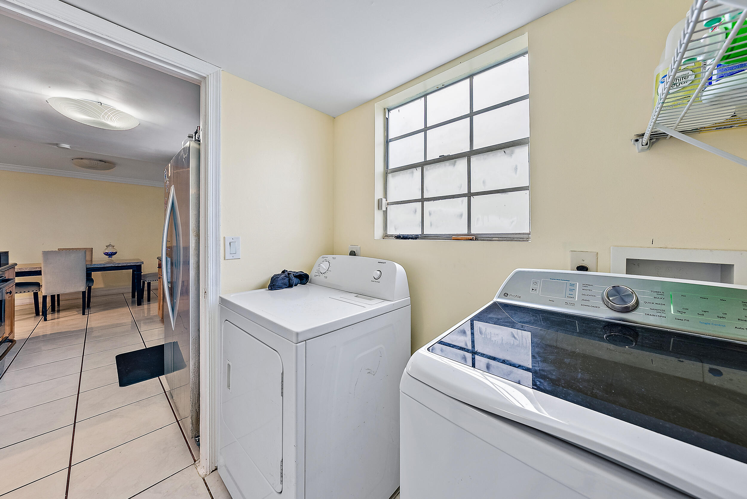 5872 Rambler Rose Way West Palm Beach, FL 33415 - Photo 13 of 30 a view of washer and dryer with kitchen island in the background