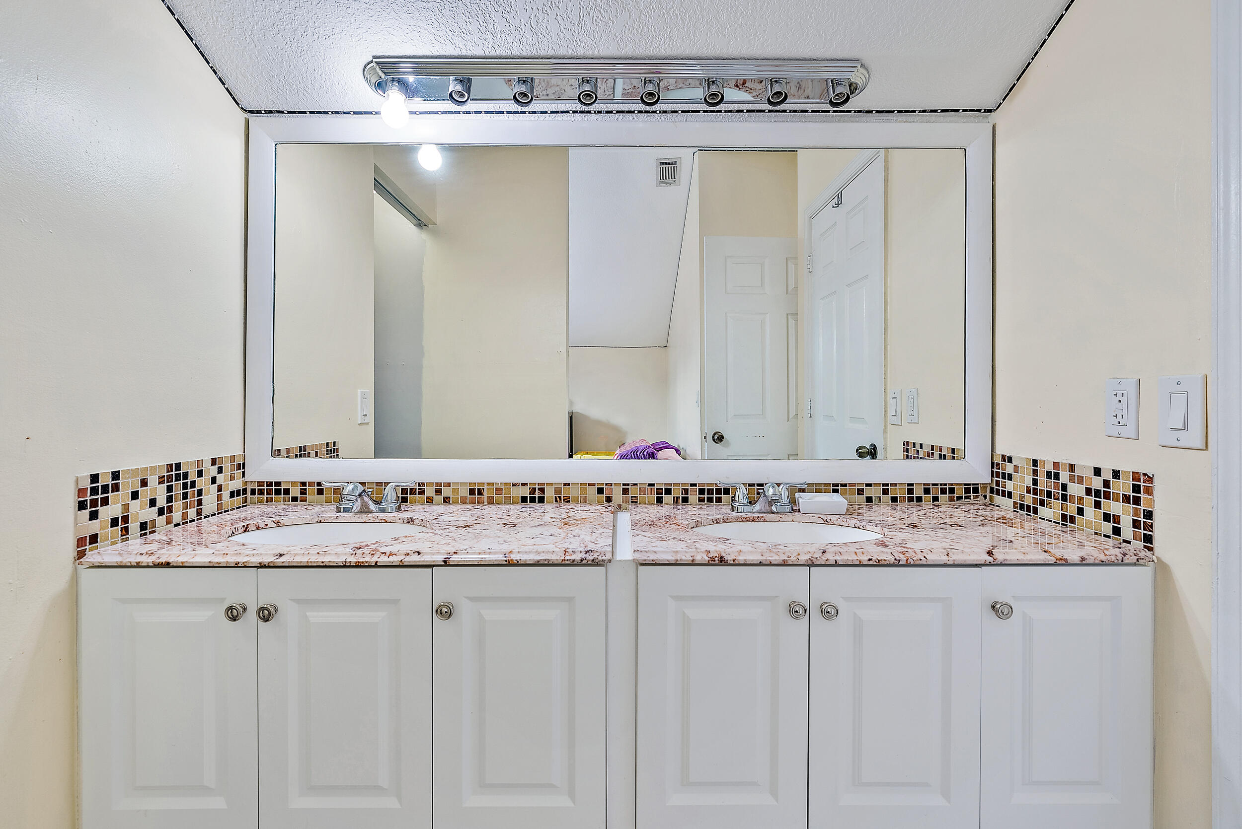 5872 Rambler Rose Way West Palm Beach, FL 33415 - Photo 16 of 30 a bathroom with a sink and a mirror