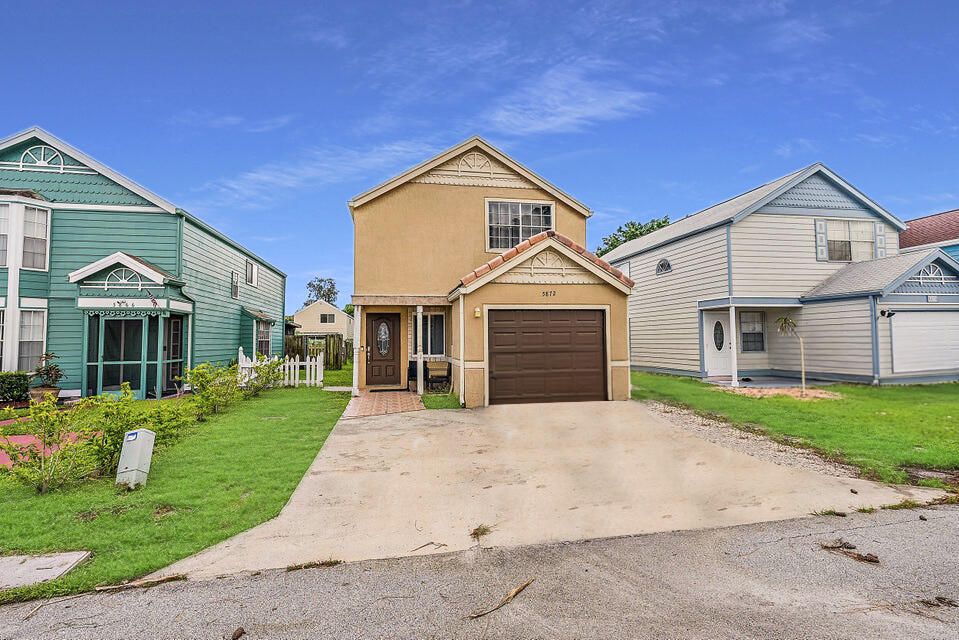 5872 Rambler Rose Way West Palm Beach, FL 33415 - Photo 2 of 30 a front view of a house with a yard and garage