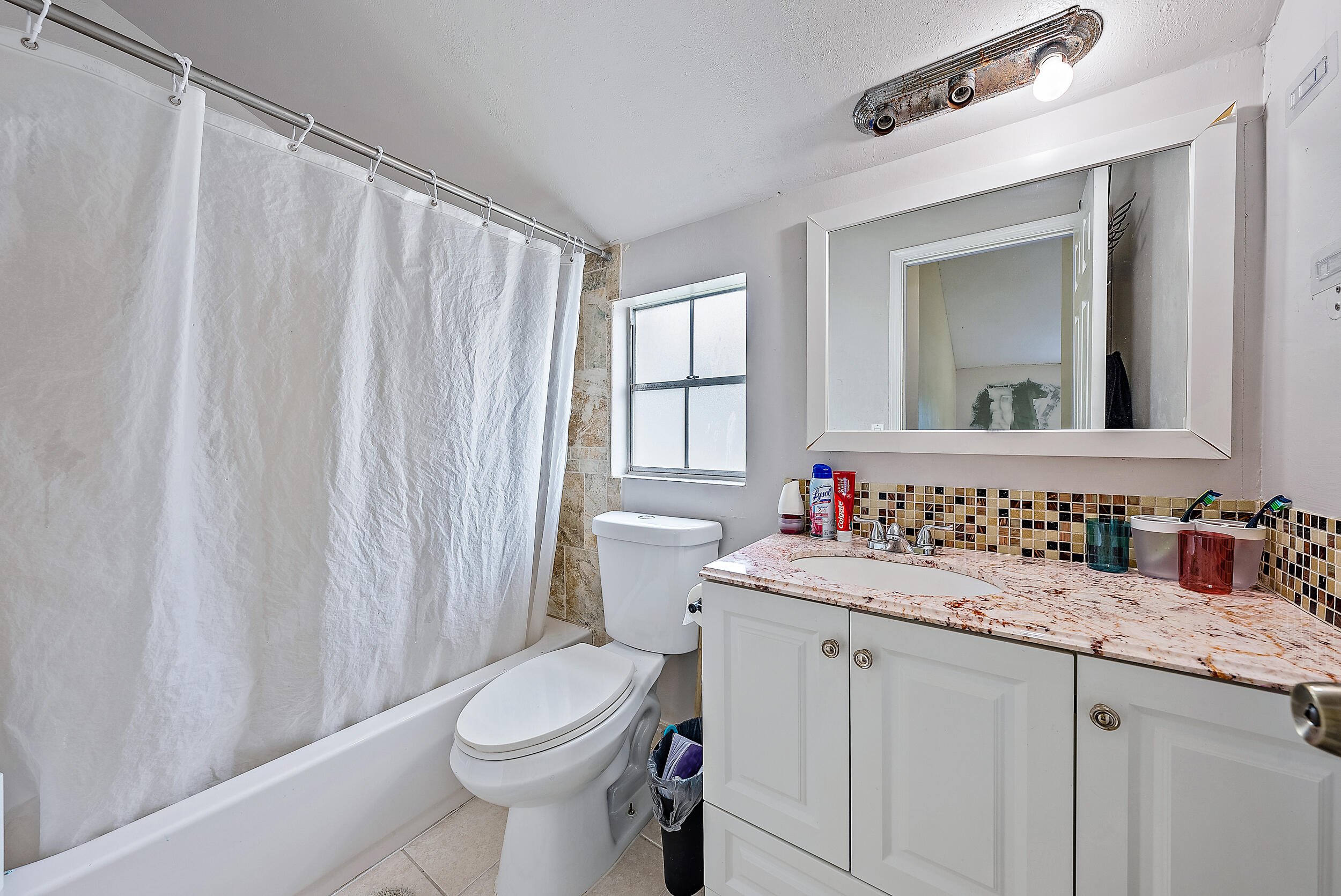 5872 Rambler Rose Way West Palm Beach, FL 33415 - Photo 21 of 30 a bathroom with a sink toilet and window