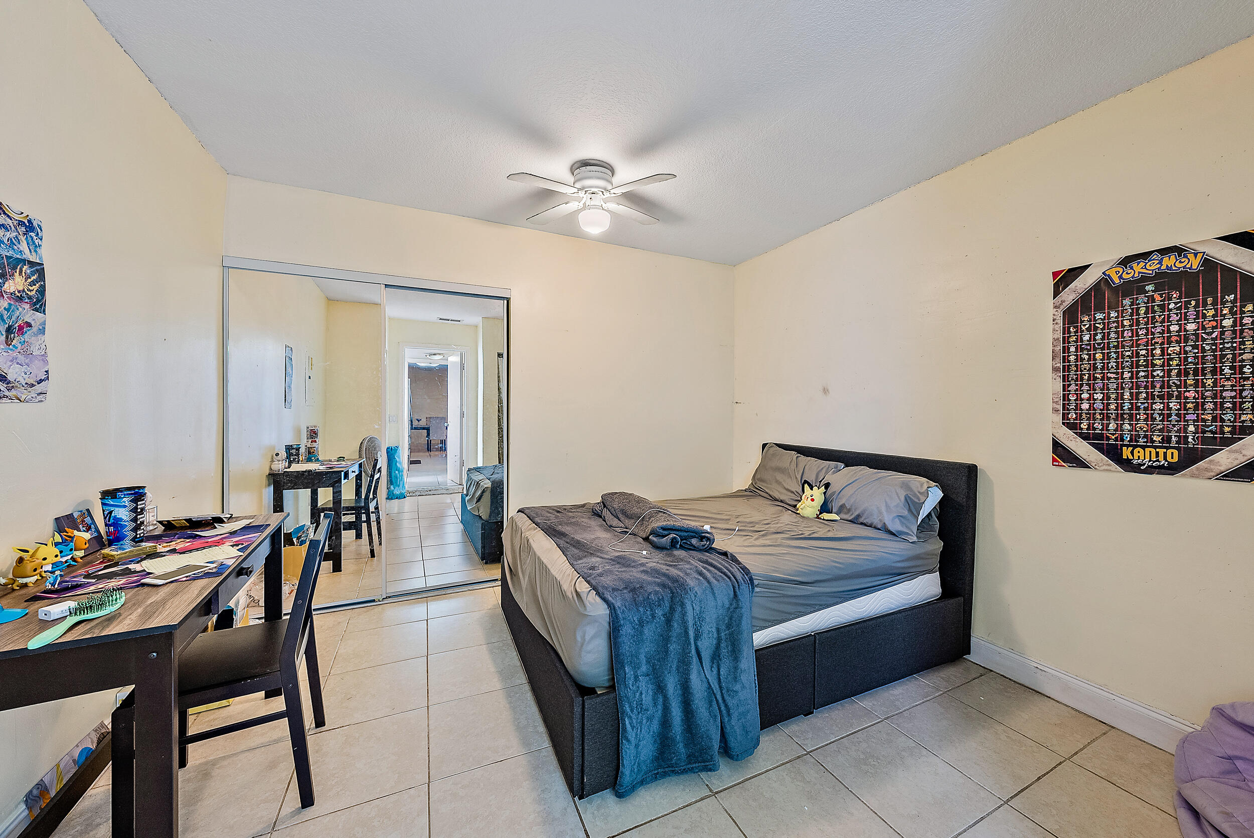 5872 Rambler Rose Way West Palm Beach, FL 33415 - Photo 22 of 30 a bed room with furniture and a chandelier