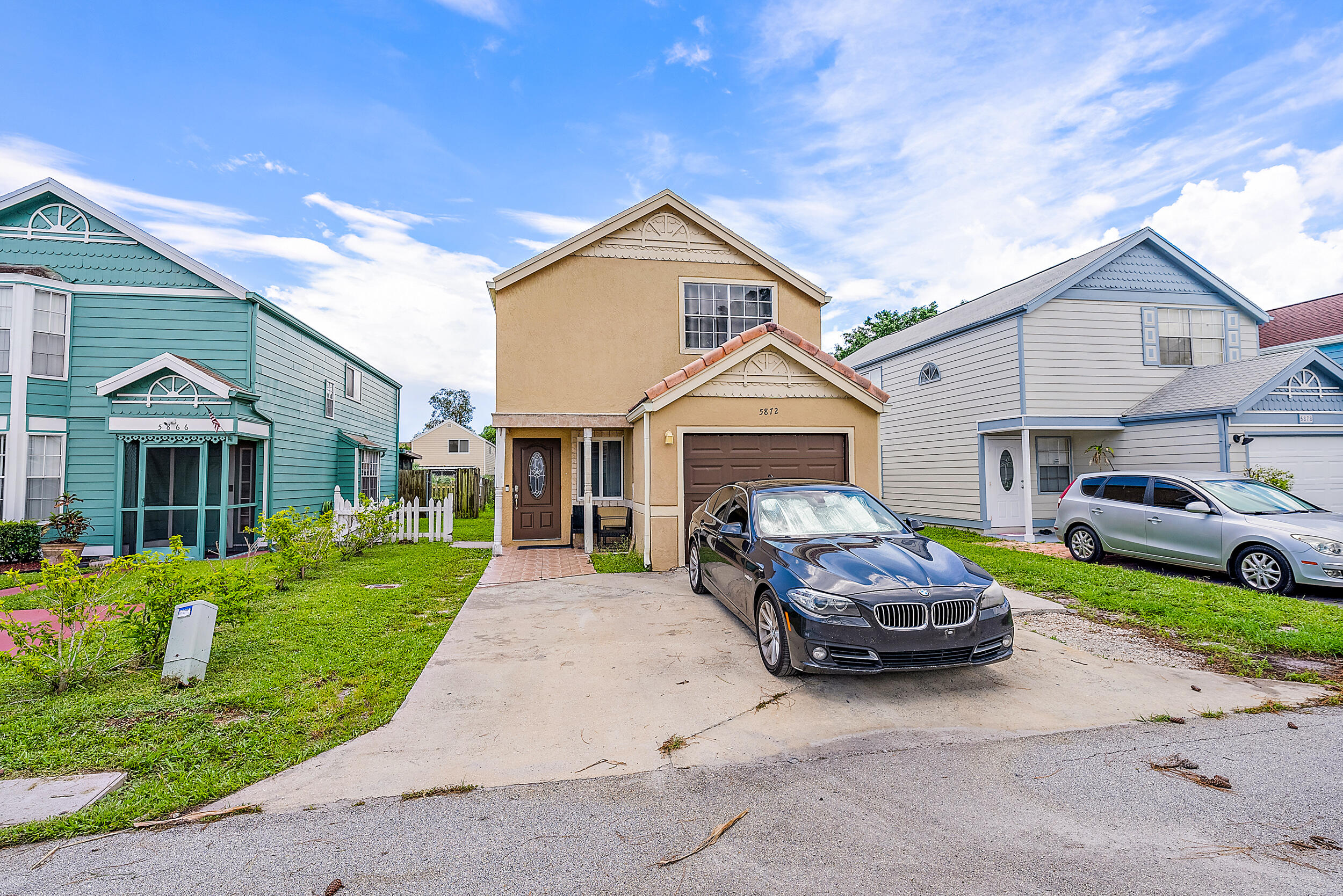 5872 Rambler Rose Way West Palm Beach, FL 33415 - Photo 3 of 30 a front view of a house with a garden and parking space