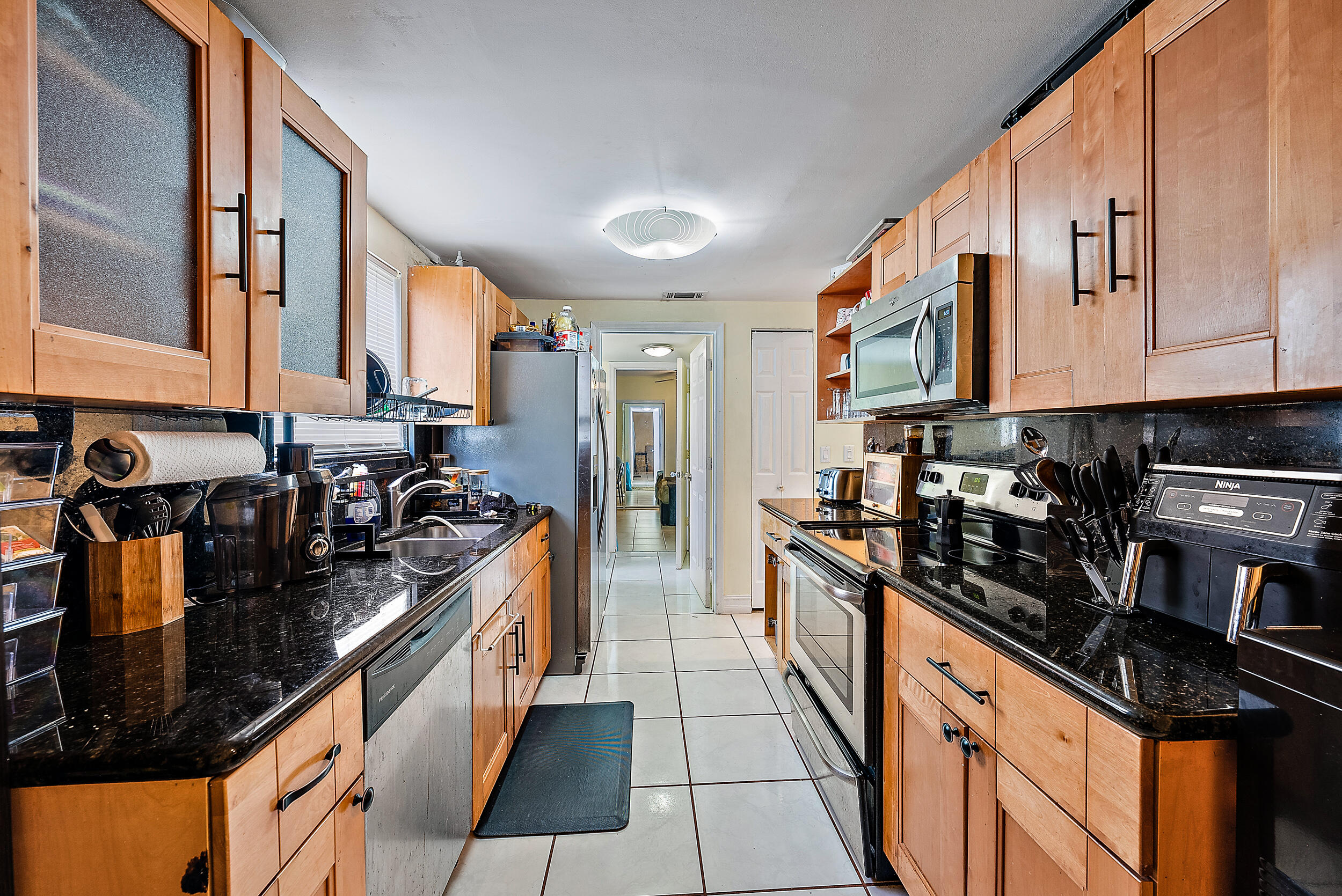 5872 Rambler Rose Way West Palm Beach, FL 33415 - Photo 10 of 30 a kitchen with stainless steel appliances granite countertop a stove and a sink