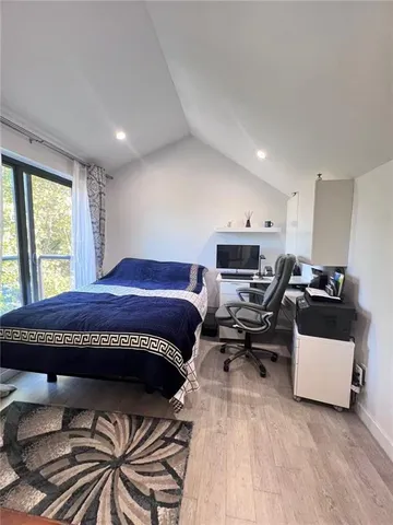 a bed room with a bed and a chair