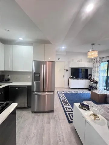 a kitchen with a refrigerator and a stove top oven