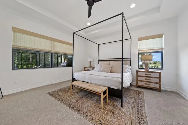 a bathroom with a granite countertop bathtub a sink and a large mirror