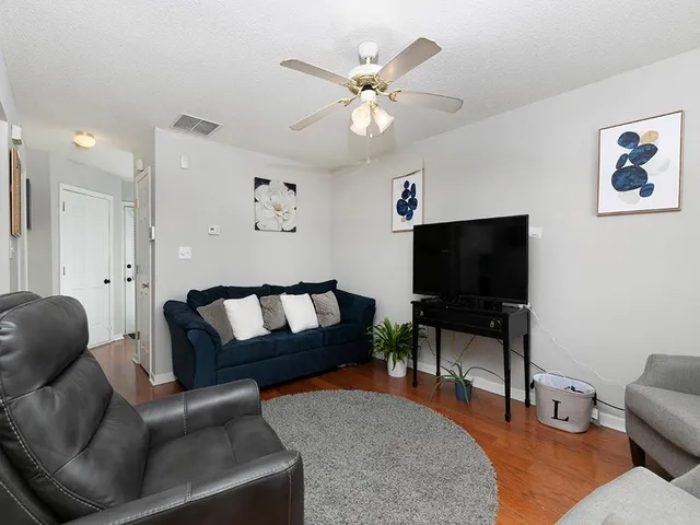 a living room with furniture and a flat screen tv