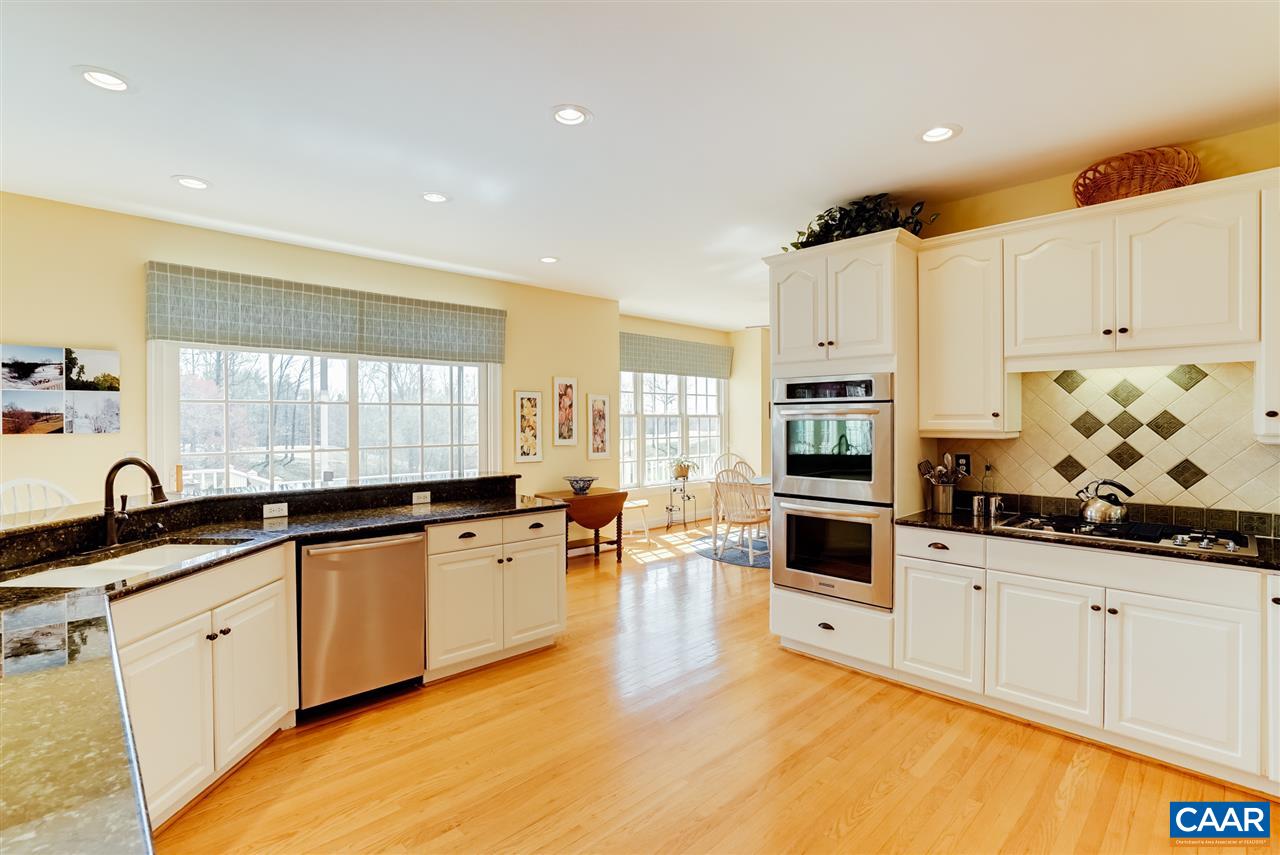 3159 Darby Road Keswick, VA 22947 - Photo 16 of 50 a large kitchen with granite countertop a sink and cabinets