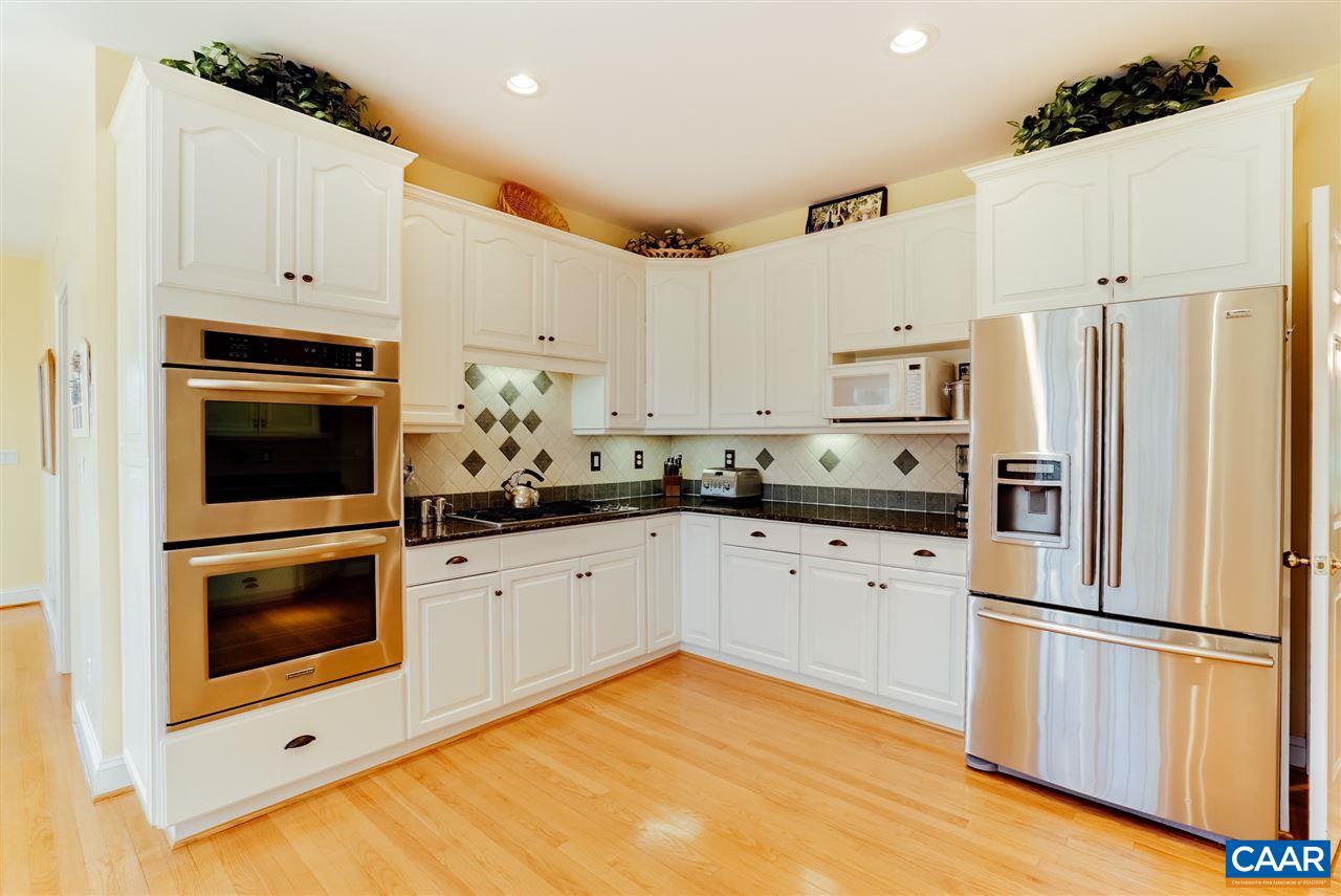 3159 Darby Road Keswick, VA 22947 - Photo 17 of 50 a kitchen with granite countertop white cabinets and white appliances