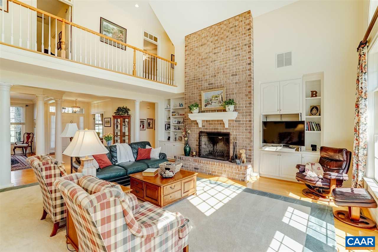 3159 Darby Road Keswick, VA 22947 - Photo 8 of 50 a living room with furniture a flat screen tv and a fireplace