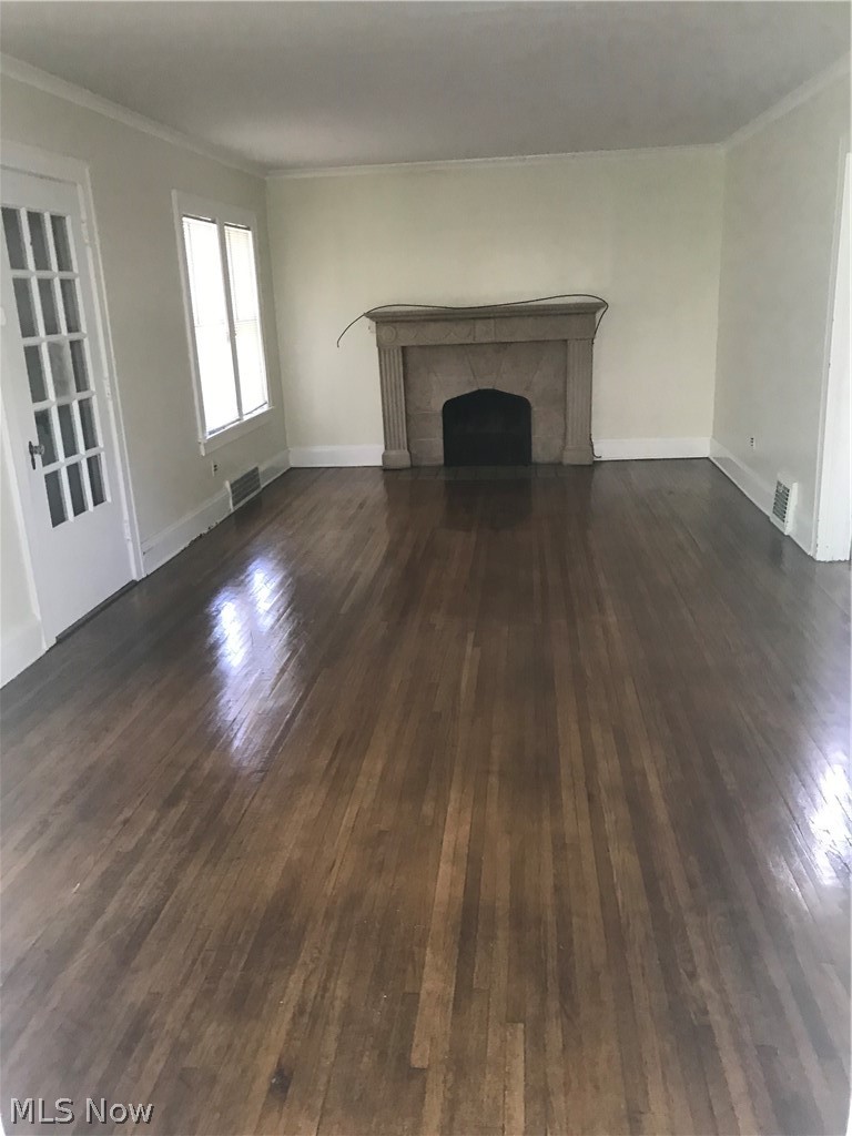 906 Montford Road Cleveland Heights, OH 44121 - Photo 3 of 20 Large living room with foyer and stone fireplace. Behind this is the sunroom