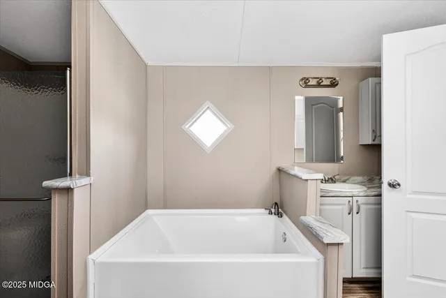 a bathroom with a bathtub and a sink