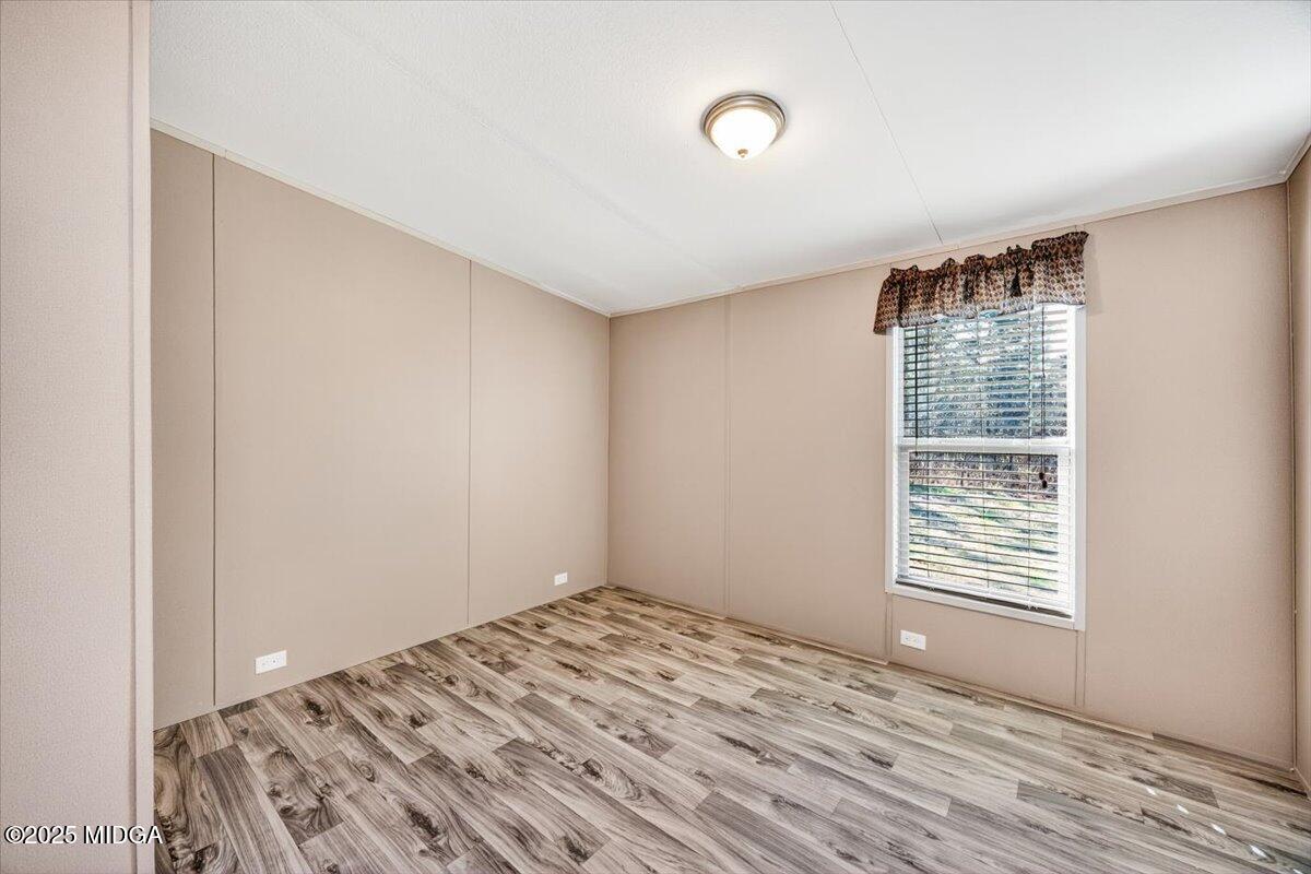 167 Mountain Springs Church Road Macon, GA 31217 - Photo 20 of 32 an empty room with wooden floor and windows