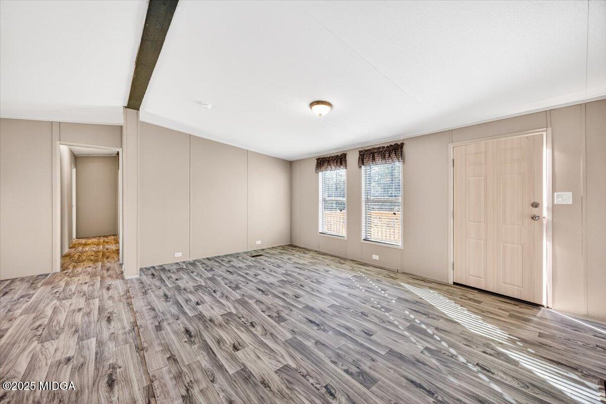 167 Mountain Springs Church Road Macon, GA 31217 - Photo 5 of 32 a view of an empty room with wooden floor and a window