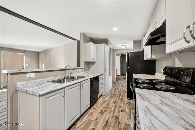 a kitchen with a sink stove and cabinets
