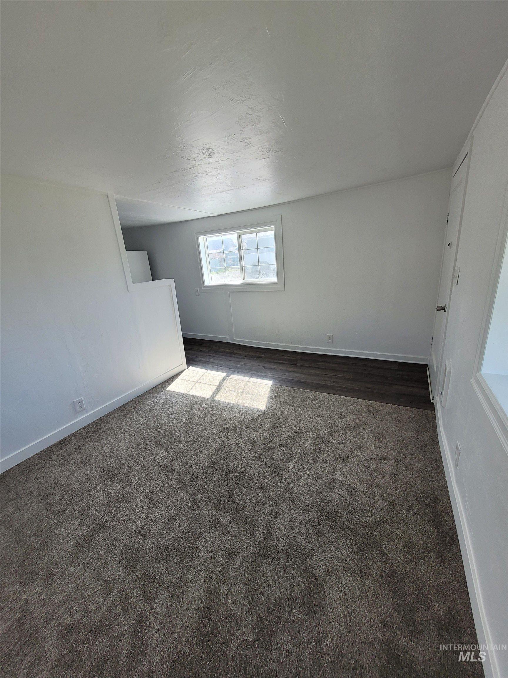 517 12th Street Clarkston, WA 99403 - Photo 11 of 16 Spare room featuring baseboards and dark colored carpet