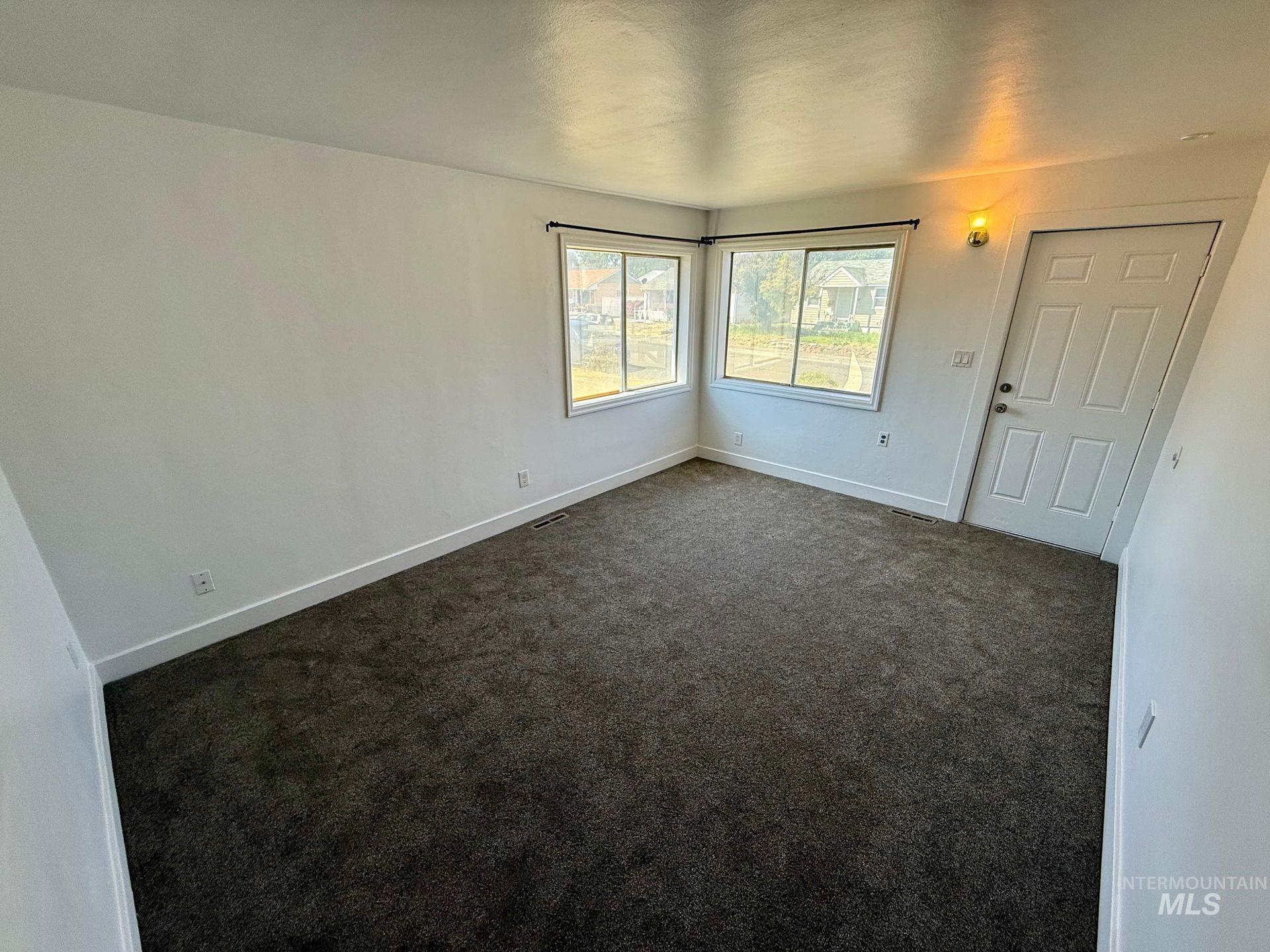 517 12th Street Clarkston, WA 99403 - Photo 4 of 16 Spare room with baseboards and dark colored carpet