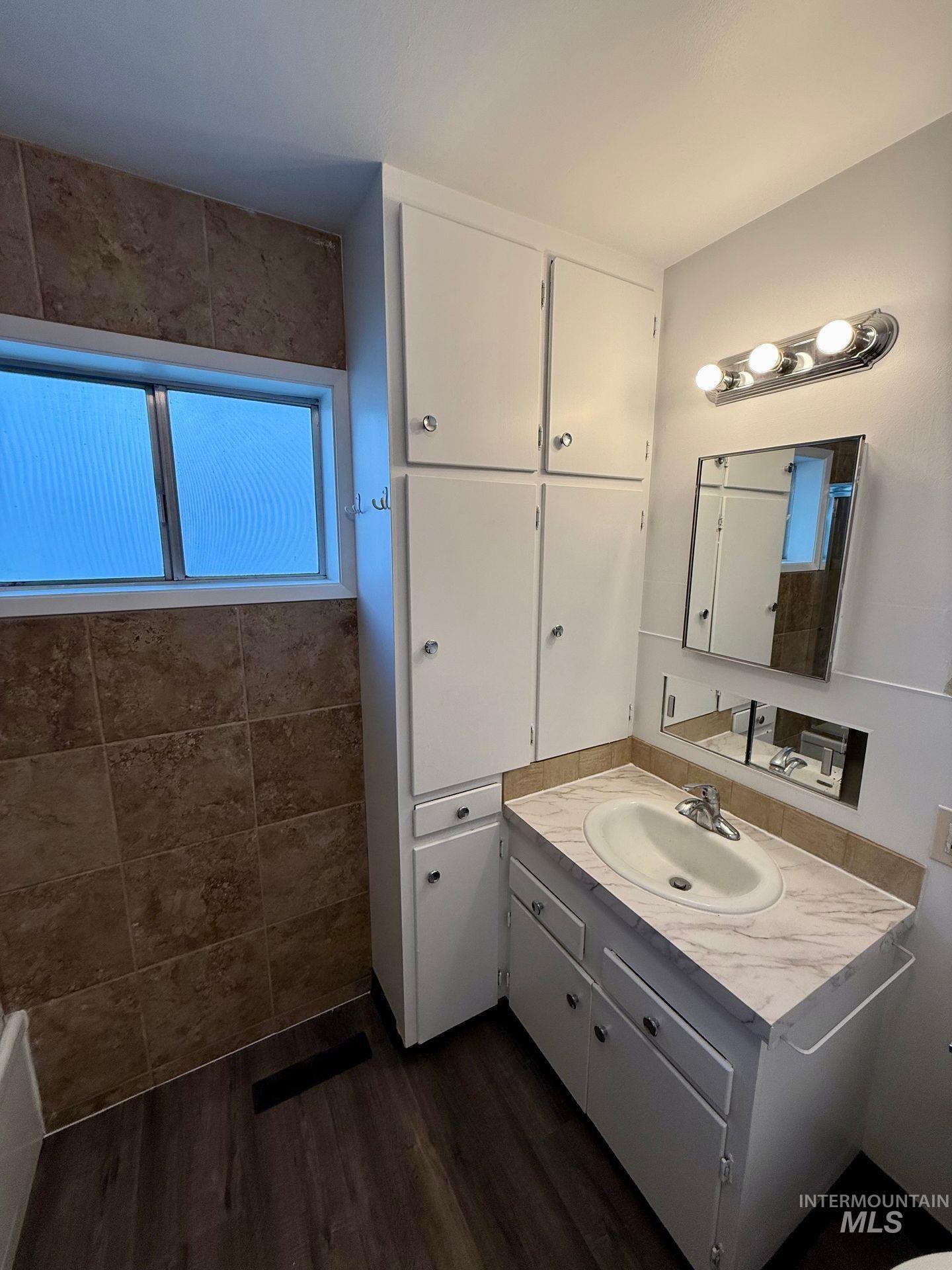 517 12th Street Clarkston, WA 99403 - Photo 6 of 16 Bathroom with vanity and dark wood-style flooring