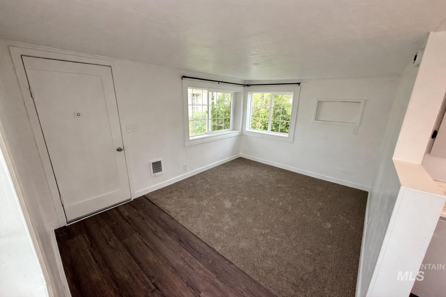 517 12th Street Clarkston, WA 99403 - Photo 8 of 16 Unfurnished bedroom with baseboards and dark wood-style floors