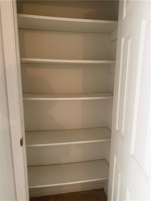 682 Bridge Way Lithonia, GA 30058 - Photo 21 of 25 a view of walk in closet with empty racks