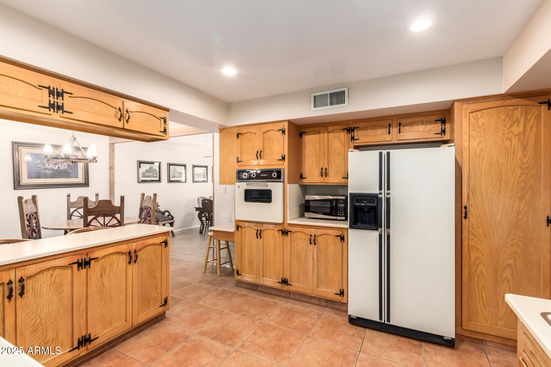 6419 East Cactus Road Scottsdale, AZ 85254 - Photo 12 of 38 a kitchen with stainless steel appliances a refrigerator and a stove