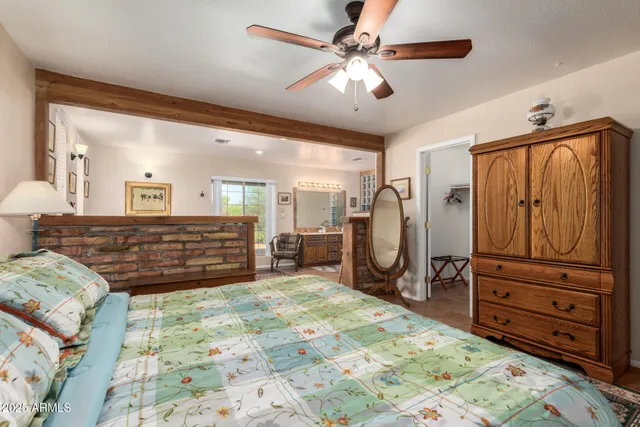 a large bedroom with furniture and a mirror