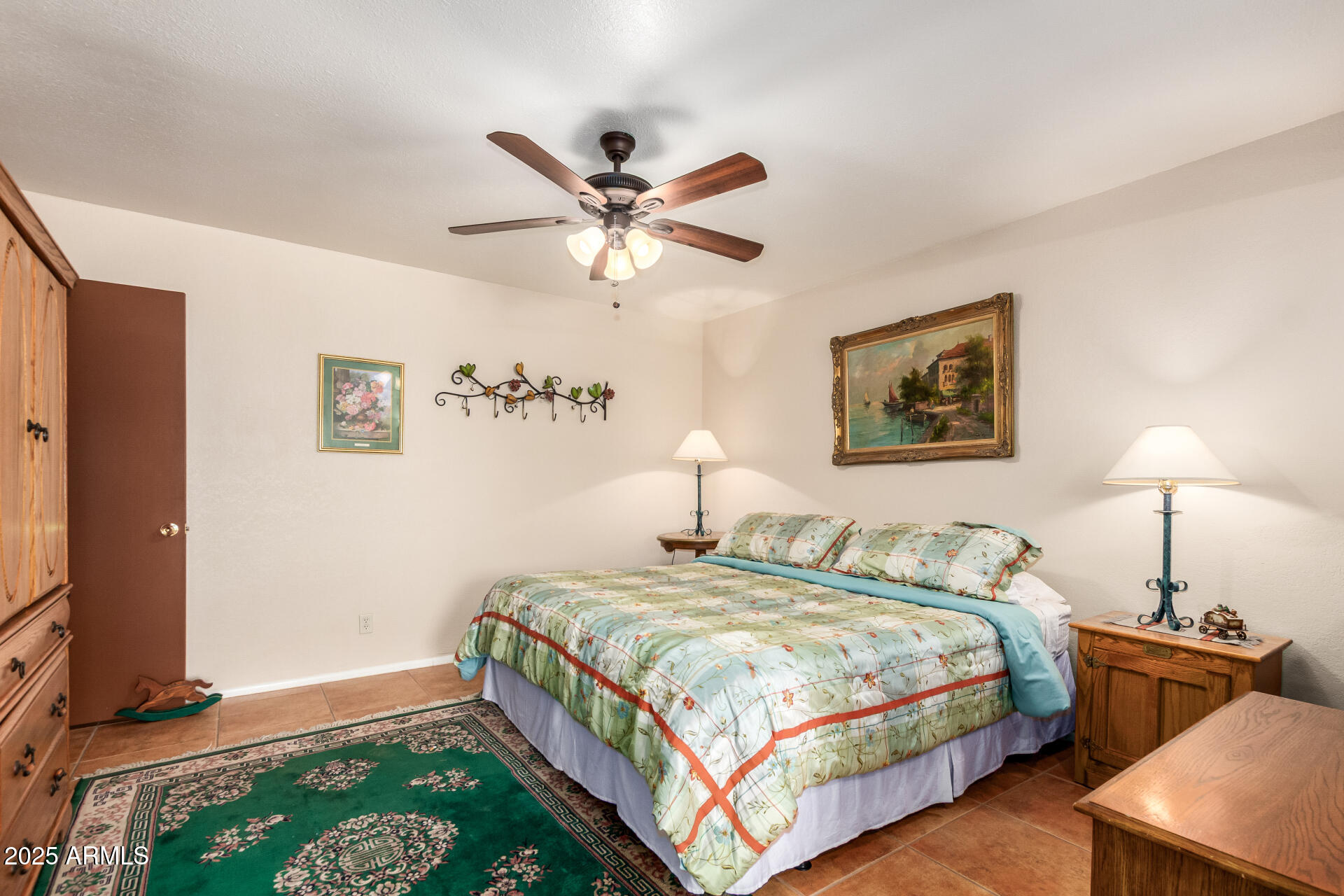 6419 East Cactus Road Scottsdale, AZ 85254 - Photo 15 of 38 a bedroom with a bed and a chandelier