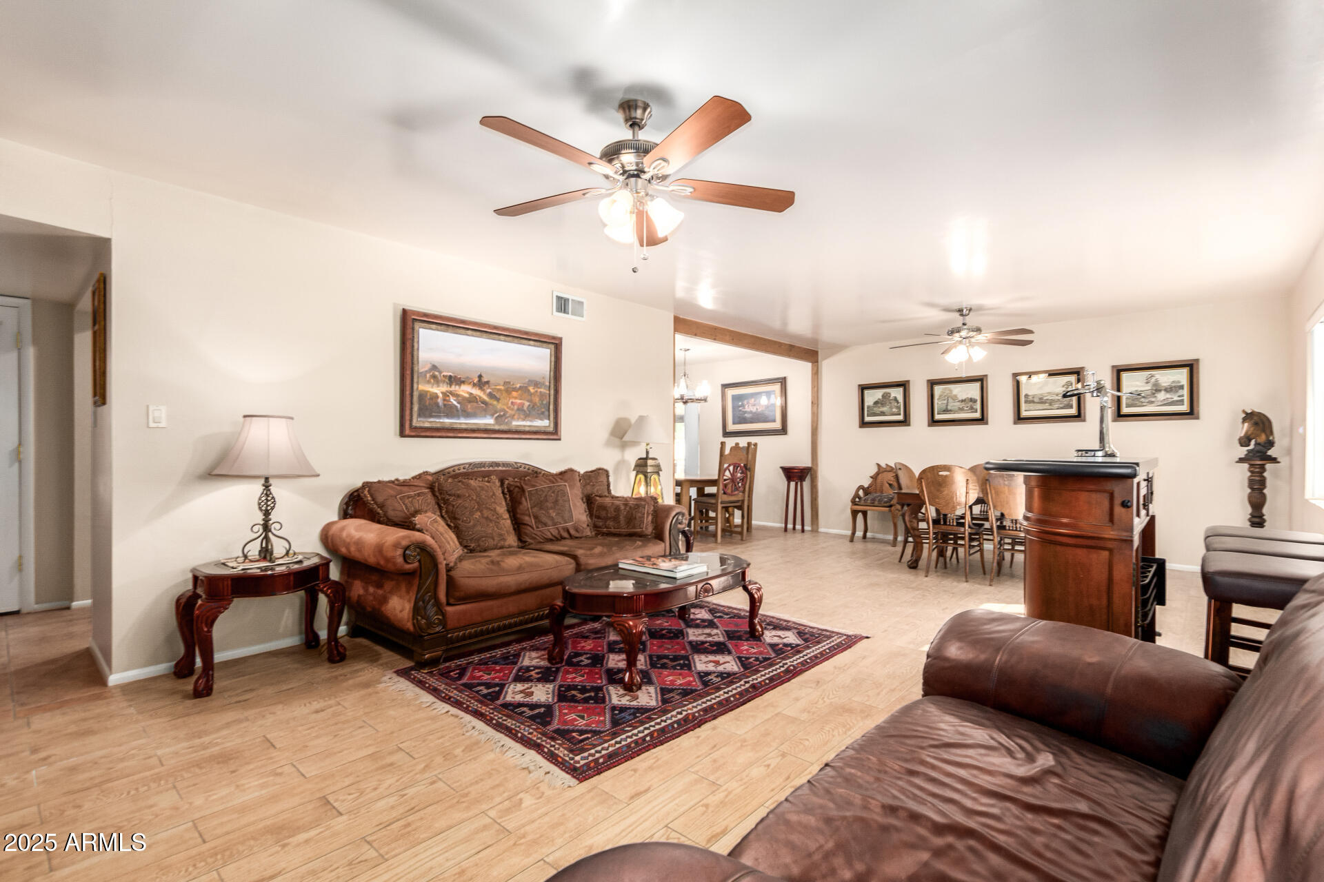 6419 East Cactus Road Scottsdale, AZ 85254 - Photo 2 of 38 a living room with furniture a chandelier and a window