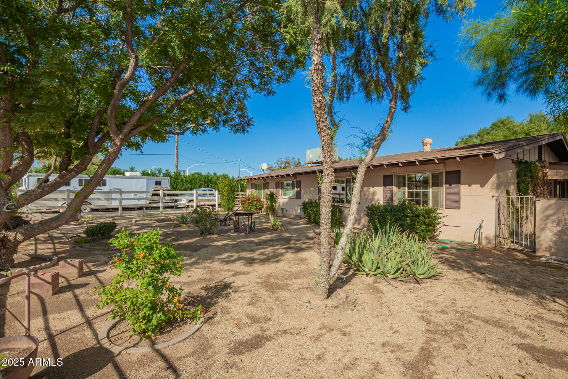 6419 East Cactus Road Scottsdale, AZ 85254 - Photo 30 of 38 a view of a house with a tree in the background
